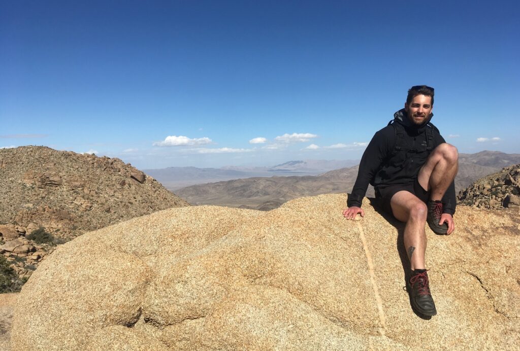 freelance content writer Tyler Tafelsky on a desert mountain