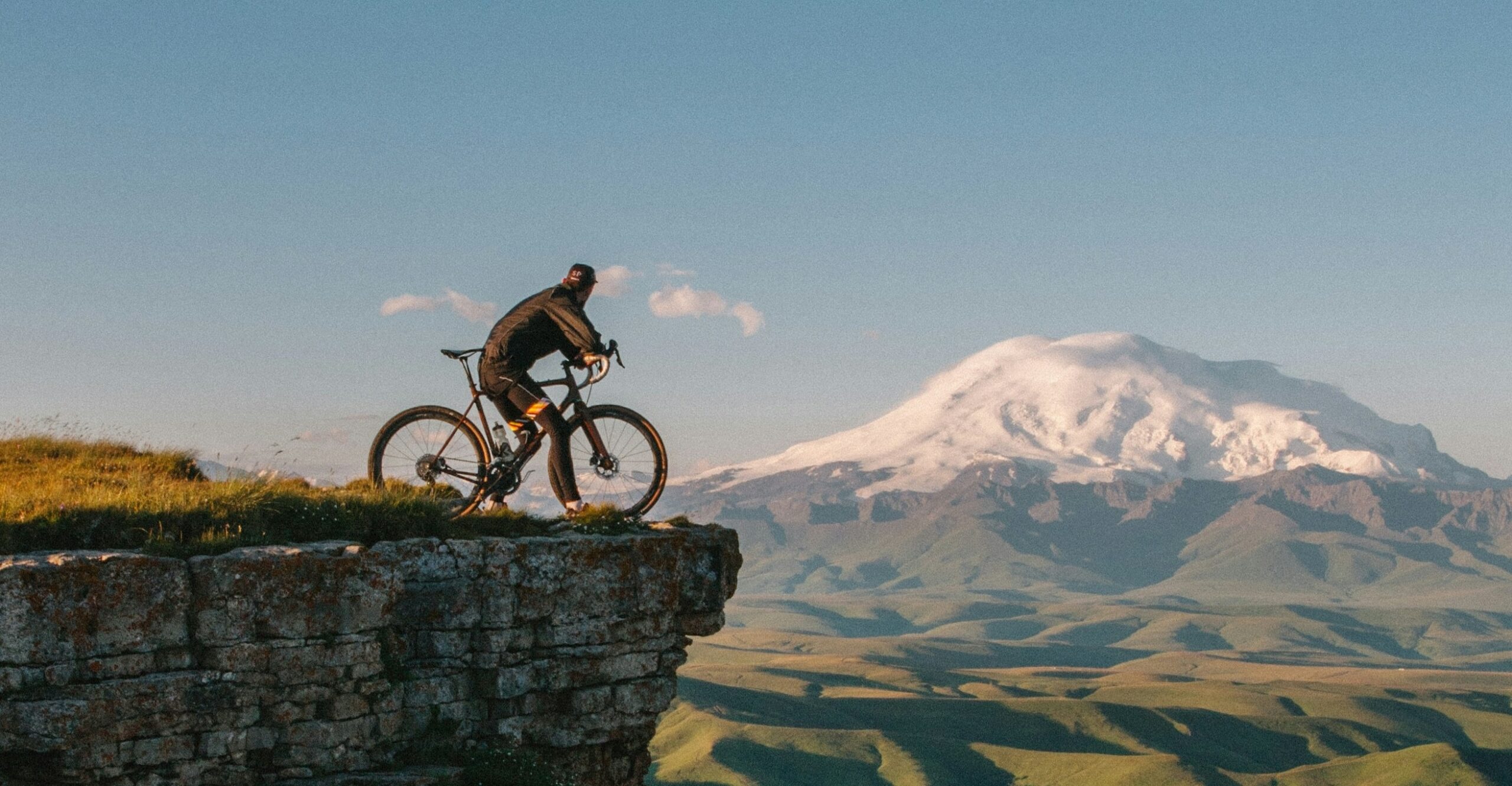 Cyclist overlooking a mountain