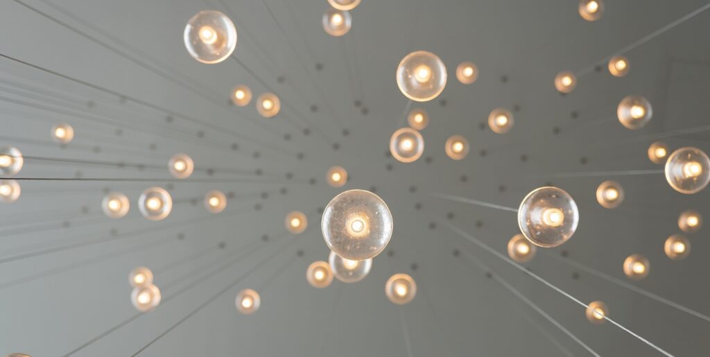 Various suspended light bulbs representing new ideas for using AI for search engine optimization (SEO) and thinking outside the box