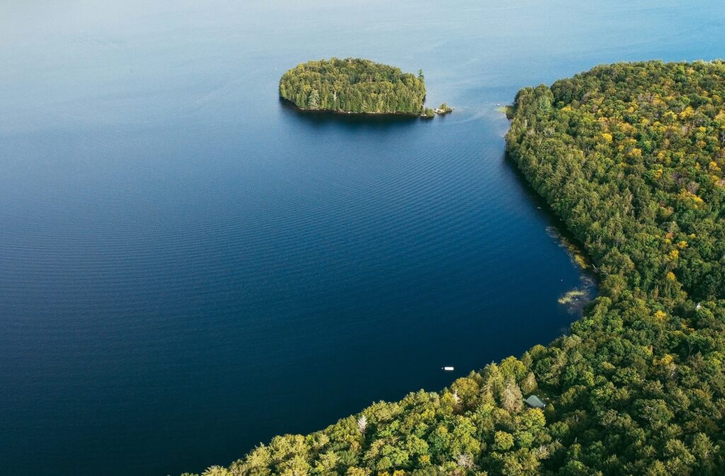 aerial view of a lake with land and an island in sight