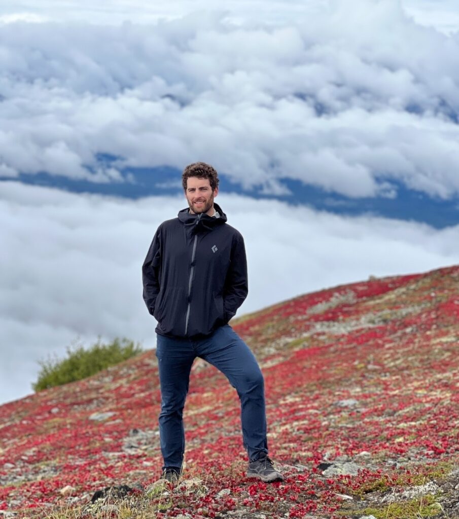 Tyler Tafelsky, freelance SEO consultant and content strategist, standing on a mountain in Alaska