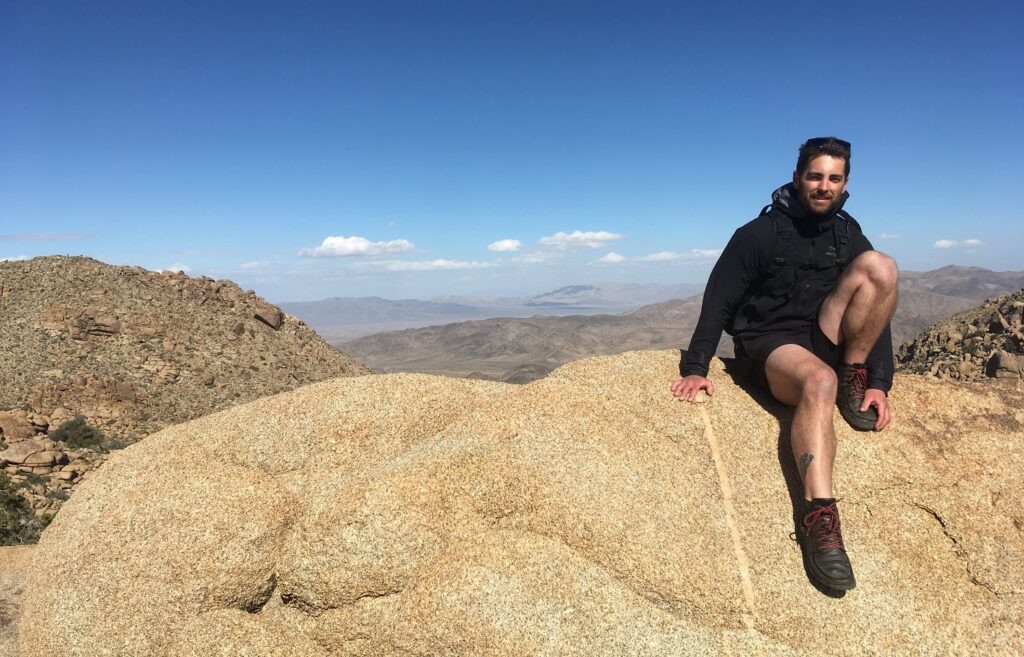 Tyler Tafelsky, freelance SEO content strategist, on a rock at Joshua Tree National Park